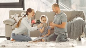A joyful family enjoying quality time and coffee in a bright living room, symbolizing love and togetherness.